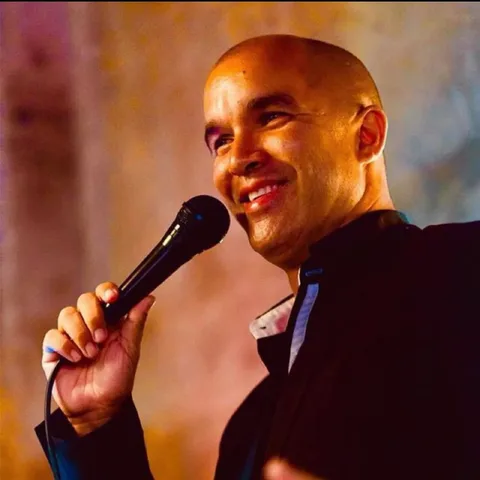 Yves Baron singing into a microphone